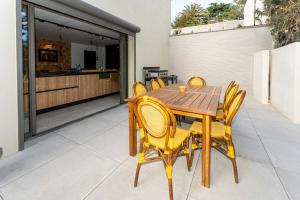 a wooden table and chairs on a patio at Villa Bellevue in Sète