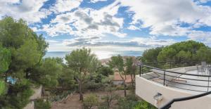 a view from the balcony of a house with trees at Villa Bellevue in Sète
