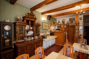 a kitchen with wooden furniture and a dining room at Penzion Harmonia in Liptovský Mikuláš