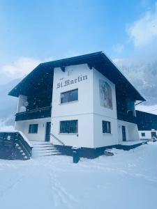 un edificio en la nieve con nieve en el suelo en Haus St. Martin, en Klösterle am Arlberg