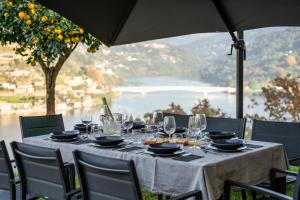 a table with wine glasses and food on it at Douro Country House in Cinfães