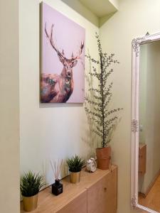a painting of a deer on a wall at Apartament z widokiem na stary rynek in Wejherowo