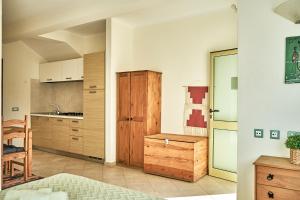 a kitchen with a wooden cabinet and a table in a room at Lovely Studio Apartment ln Centre SantaMaria in Santa Maria