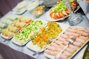 a table topped with lots of different types of food at Hotel 3 Trio in Białystok