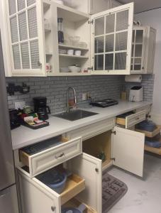 a kitchen with white cabinets and a sink at Fantastic Suite in Las Vegas