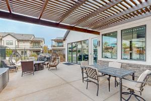 a patio with a table and chairs and windows at Santa Clara Starlight-Ocotillo 9 in Santa Clara