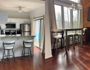 a kitchen with a counter and a kitchen with stools at Cozy Condo in Wintergreen Resort That Sleeps 4! in Lyndhurst