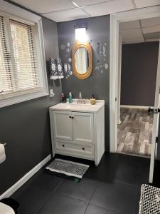 a bathroom with a white sink and a mirror at Home Away in Conyers