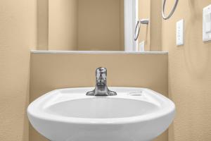 a bathroom sink with a faucet in a bathroom at Luxurious Townhome - 5 minutes from Disney in Orlando