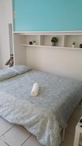 een wit bed met een kussen erop bij Bonito y moderno estudio con vistas al mar in Benalmádena