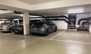 a parking garage with two cars parked in it at Hotel Restaurant Krokodil in Heidelberg