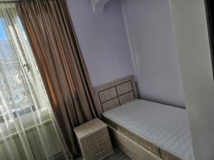 a small bedroom with a bed and a window at Квартира отдыха in Ijevan