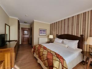 Postel nebo postele na pokoji v ubytování Likoria Hotel