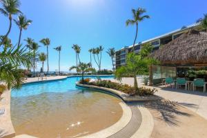 a swimming pool with palm trees and a building at Beacon Reef 307 in Islamorada