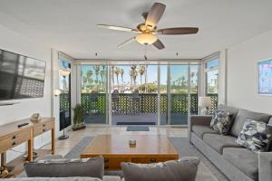a living room with a couch and a ceiling fan at Belmont Ocean Views - Massive Private Deck, Grill & Parking in San Diego