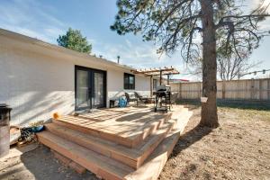 una casa con terraza de madera junto a un árbol en Inviting Boulder Apartment with Private Yard!, en Boulder