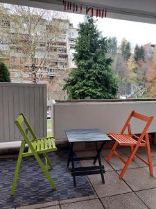 two chairs and a table and two chairs on a balcony at Apartment Ciglane - Pet friendly in Sarajevo