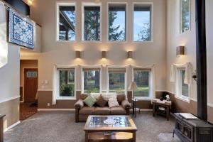 a living room with a couch and some windows at Las Casas Feliciano - Lummi Island in Lummi Island