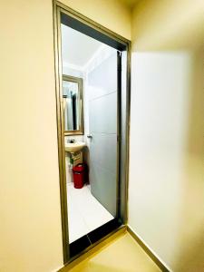 a mirror in a bathroom with a sink and a toilet at Kromatic Hostel in Medellín +45 photos