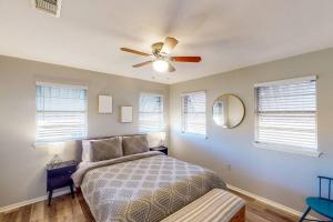a bedroom with a bed and a ceiling fan at New Cozy Home 10 Min to Magnolia and Baylor in Waco