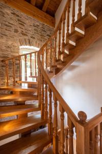 a wooden staircase in a house with wooden floors at Nostos Country House in Tsagarada