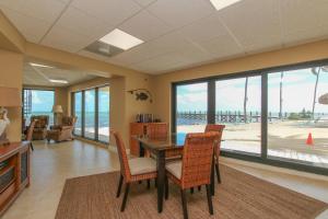 a dining room with a table and chairs and a view of the beach at Beacon Reef 310 in Islamorada