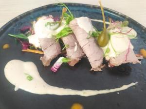 a plate of food with meat and a salad at Hotel Butterfly Wellness & Spa in Rimini