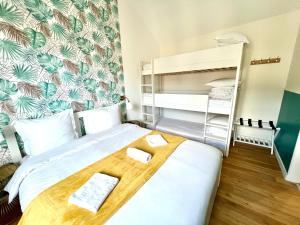 a small room with a bed with a wooden board on it at Guest house close to Disney! in Montévrain