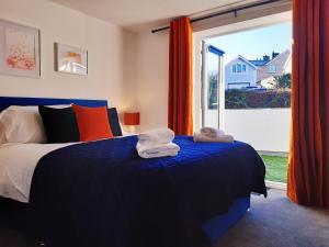 a bedroom with a bed and a large window at No's 2 and 5 Llewelyn Apartments in Llanberis +17 photos