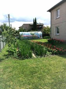 a garden with a mural on the side of a house at Town House in Kėdainiai