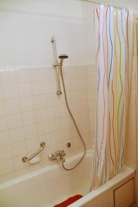 a shower curtain in a bathroom with a tub at Alpenheim in Garmisch-Partenkirchen