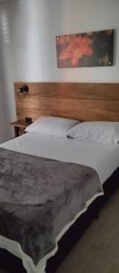 a bedroom with a bed with a wooden headboard at JARDIN CAFETERO in Trujillo