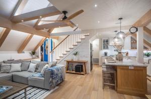 a kitchen and living room with a couch and a table at Neptune Experience in Encinitas
