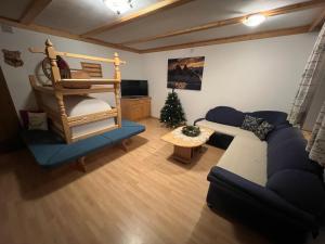 a living room with a couch and a bunk bed at Ampio appartamento di 200mq nel cuore di Antermoia in Antermoia