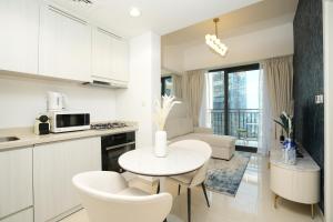 a kitchen and living room with a table and chairs at Cozy Flat in Business Bay in Dubai