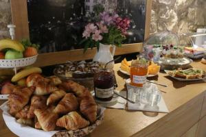 a table with a bunch of different types of food at Hotel At the Green Grape in Prague