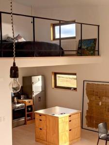 a room with a kitchen and a living room at Look Out - Loft in Puerto Natales