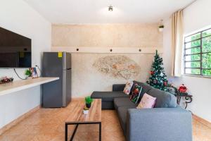 a living room with a couch and a christmas tree at Casa Maya Villa with Private Pool Bar and Parking Merida in Mérida