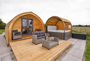 a gazebo with a hot tub on a deck at Little Meadow Pods with Hot Tub in York