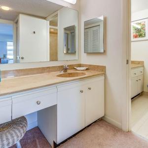 a white bathroom with a sink and a mirror at Beacon Reef 406 in Islamorada