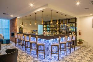 a bar with a row of stools in a restaurant at Jose Antonio Deluxe in Lima