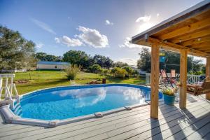 a swimming pool on a deck with a pergola at Moore Haven Getaway with Deck and Private Pool in Moore Haven