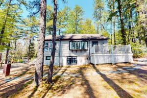 a house in the middle of a forest at Let's Bay Together in Ossipee