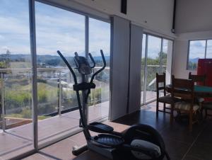 a room with an exercise bike in front of a window at Hotel Loma Encantada, Guatapé - Piedra del Peñol in Guatapé