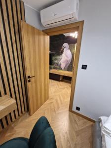 a reflection of a white bird in a mirror at Apartamenty Sebastiana in Krakow