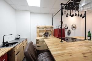 a kitchen with wooden cabinets and a counter top at Studio Trier-Petrisberg in Trier