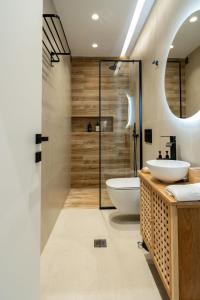 a bathroom with two sinks and a shower at CLIC suite and family in Ioannina