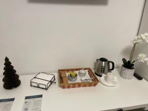 a table with a tray of coffee and a tea set at Nest & Relax in Trento