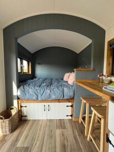 a bedroom with a bed in the middle of a room at Old Quay Escape in Tenby