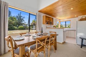 a kitchen and dining room with a table and chairs at Wanaka Tranquility - Wanaka Holiday Home in Wanaka